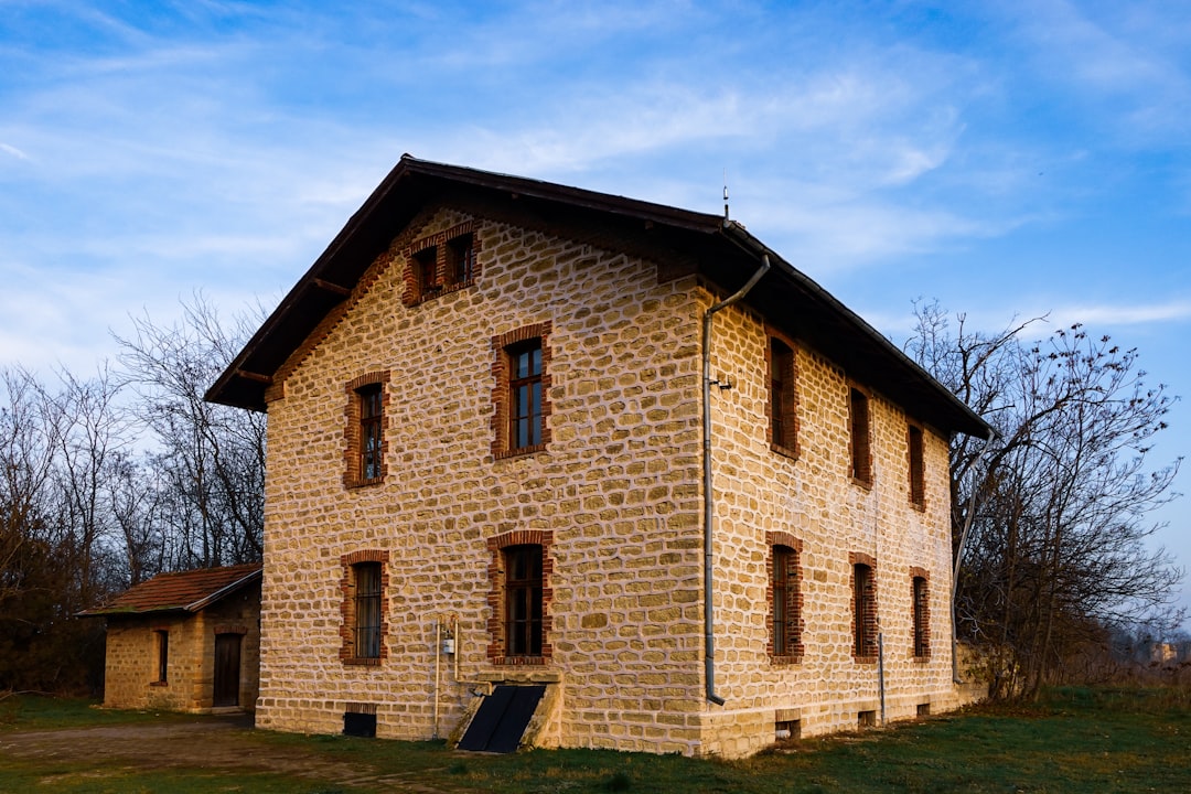 an old brick building with windows and shutters